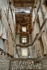Fototapeta na wymiar The interior of an abandoned crumbling building. A dying city. Frightening atmosphere