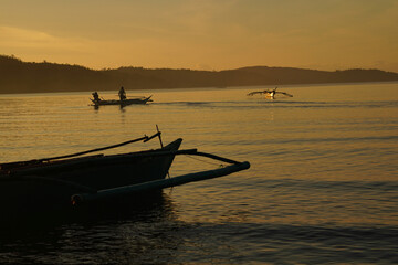 First light. Early morning & traditional fishermen are heading out. Bulalacao, Oriental Mindoro,...