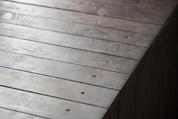 wooden table with a view of blurred beverages bar backdrop