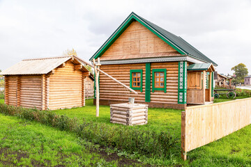 Fototapeta na wymiar Traditional Tatar wooden house built from wood logs with outbuildings