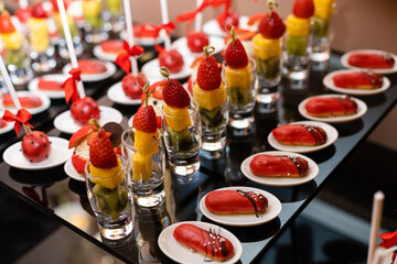 Tasty candy bar for Birthday party on table against color background