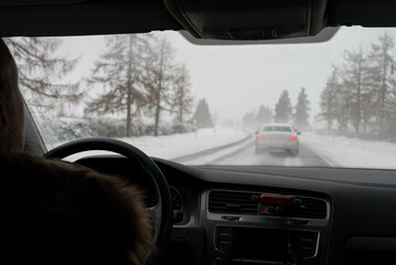 Blowing snow on the road. Difficult weather conditions on the road.