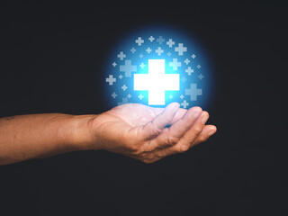 Health care and business health insurance concept. Virtual medical icons on the palm of a senior man against a black background