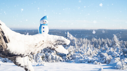 Winter snow snowman background landscape - Little cute Snowman sits on branch of tree in snow snowy black forest with snowflakes and sunshine