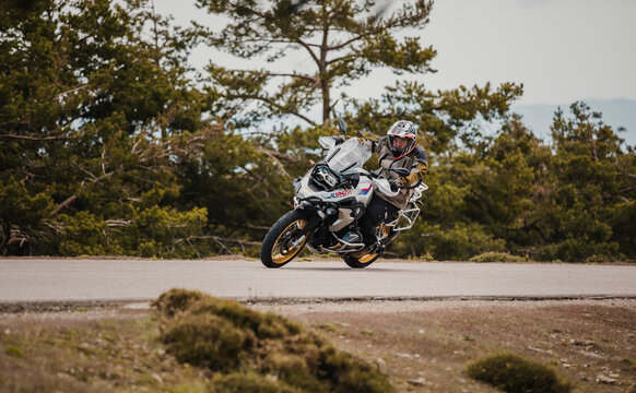 Sierra de los Filabres, Spain - May 5th 2021: Motorbike rider riding BMW R 1250 GS motorcycle in a mountain road across beautiful turns, during Dunlop Xperience event in Sierra de los Filabres, Spain.