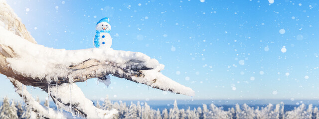 Winter snow snowman background panoramic banner panorama - Little cute Snowman sits on branch of tree in snow snowy black forest landscape with snowflakes and sunshine