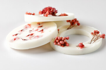 Aroma sachet with dried flowers with coconut or organic soy wax. Close up on white background