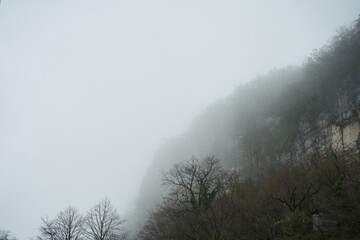 Obraz na płótnie Canvas View of the high-mountain valley, heavy fog. Limited visibility