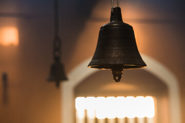 Metal golden bell in a buddhist temple with light.