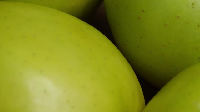 Green apple peel, macro video filming. Apples of the Reinette Simirenko variety, close-up.
