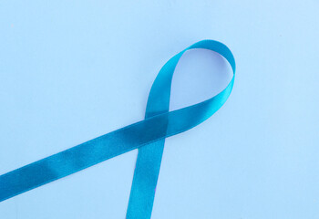 Blue ribbon on white background prostate cancer awareness concept