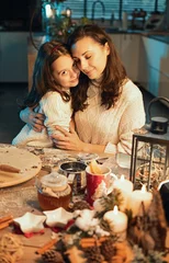 Foto op Canvas Mom and her daughter prepaaring gifts for Christmas © konradbak