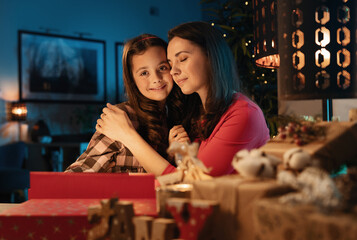 Happy mom and her daughter waiting for Christmas