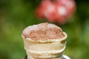 Delicious chocolate ice cream with teeth marks in waffle cup