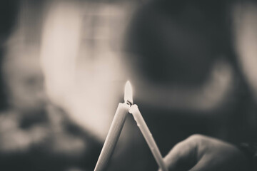 burning candle in the hand