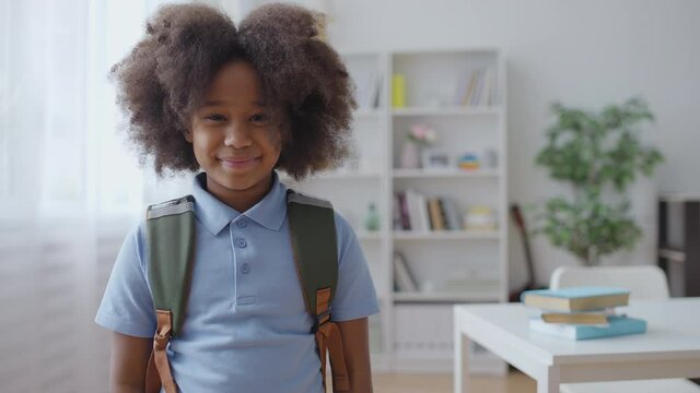 Portrait of smiling African American girl with backpack, first day of school