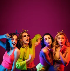 Fotobehang Group of four sexy beautiful young happy women © konradbak