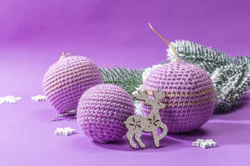 Crocheted Christmas balls and festive New Year decor in a fashion lilac very peri color