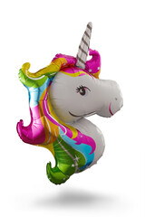 Shot of a balloon shaped as a unicorn head. It has a silver horn with lines and a multicolored mane. The multicolored photo is taken on a white background. © Redumbrella