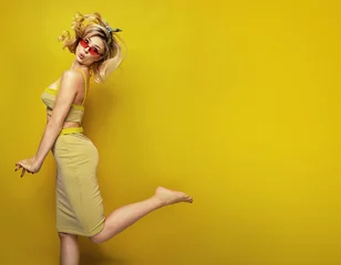Foto op Plexiglas Young blonde woman over yellow background © konradbak
