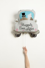Shot of a multicolored balloon shaped as a car with an inscription 