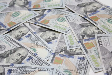 100 dollar US banknotes placed on a white background.