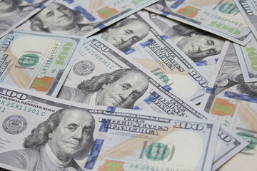 100 dollar US banknotes placed on a white background.