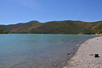 Emerald water of the mountain lake Abrau.
