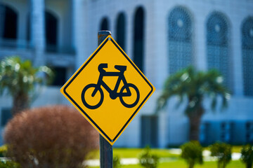 Diamond shaped sign with a bicycle. Alerting car drivers about a large number of cyclists