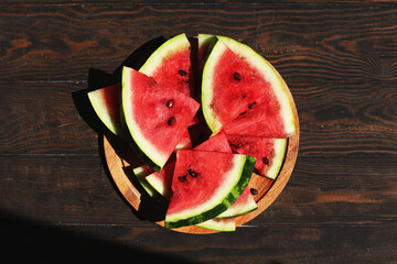 Ripe sliced watermelon on wooden background