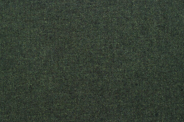 A piece of green cotton material as background. Cotton texture. Selective focus