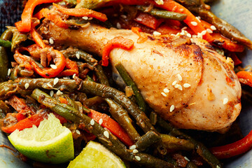 Fried chicken legs and a vegetable side dish