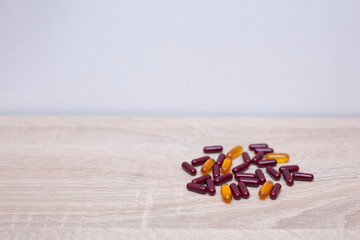 capsule pills on wooden table