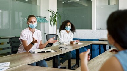 Female employees discussing at meeting in office