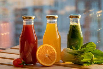 glass bottles with colorful fresh juice, fruit, and vegetable smoothies. bottle of juice