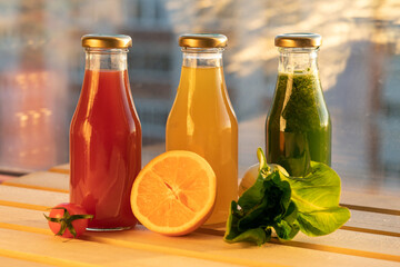 glass bottles with colorful fresh juice, fruit, and vegetable smoothies. bottle of juice