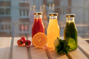 glass bottles with colorful fresh juice, fruit, and vegetable smoothies. bottle of juice