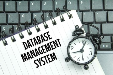 laptop keyboards, alarm clocks and notebooks with the words database management system