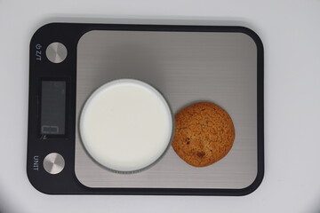 A glass of kefir on the scales. Weight loss, diet and weight control. Still life with healthy food...