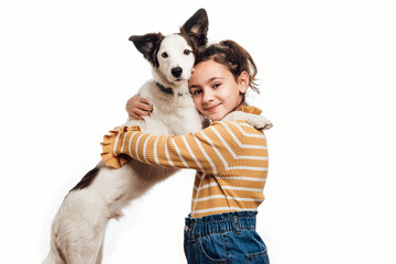 A young girl looking at the camera with her mongrel dog. Love between owner and dog. Isolated on...