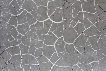 Background with cracks in gray paint on the wall