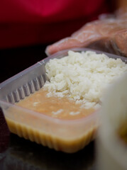 Packed dinner with meat, rice, beans and cabbage