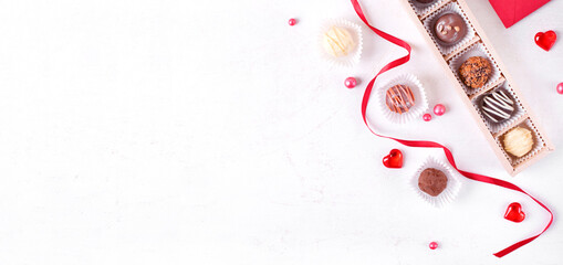 Web banner with assorted chocolate sweets on the white table. Valentines day dessert. Confectionery...