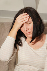  Middle Aged mature woman having headache, migraine. Woman in pain, Sad, tired, stressed.
