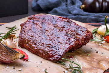 grilled Denver steak on the Board on dark table