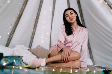 Asian girl sit in wigwam tent with map at home
