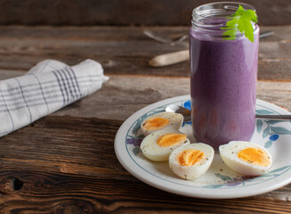 Low carb breakfast with a berry smoothie and boiled eggs
