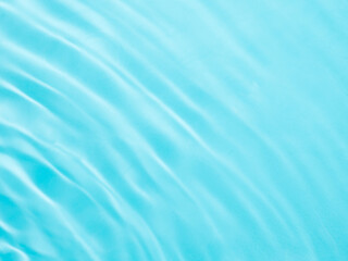 Fototapeta premium Ripple water texture on blue pool background. Shadow of water on sunlight. Mockup for product, spa or travel background. Marble blue water surface as wallpaper background
