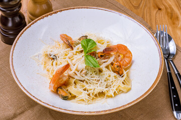 Pasta fettuccine with shrimps and parmesan on plate