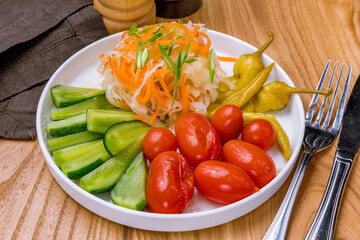 plate of pickles on wooden table side view